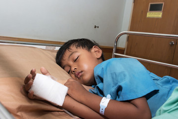 Little boy sick in the Hospital with saline intravenous