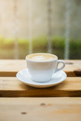 hot latte art on wood table background