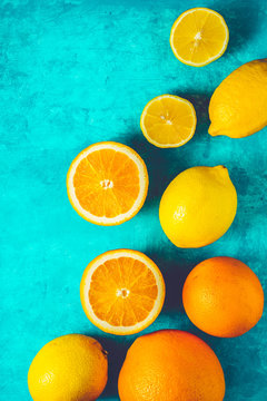 Lemons and oranges on the cyan background vertical