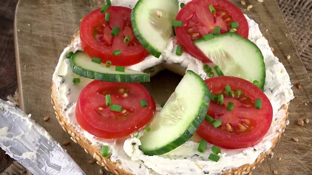 Rotating Bagels with Cream Cheese and vegetables as seamless loopable 4K UHD footage