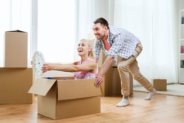 Fototapeta na wymiar couple with cardboard boxes having fun at new home