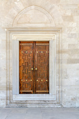 Fototapeta premium Old Wooden Door on Grunge sandstone Wall. Temple.