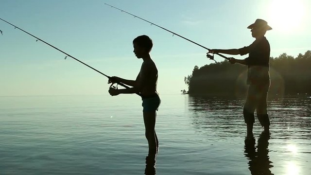 Father and son fishing on the lake.