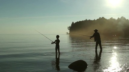 Father and son fishing on the lake.