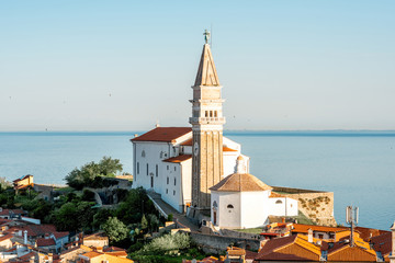 Fototapeta premium Aerial city scape view on Piran town with church tower and Adriatic sea on the background in Slovenia
