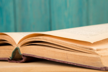 Open book on the desk over wooden background