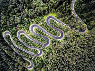 Drone view of a curvy road in Romania - obrazy, fototapety, plakaty
