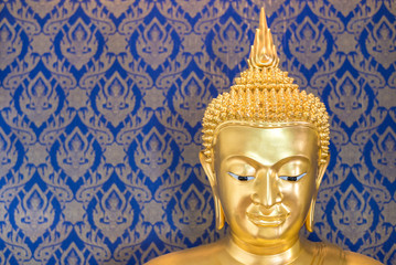 golden budhha statue in blue thai style background