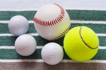 Different balls on a striped towel