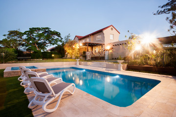 House and swimming pool decoration at evening with flashing ligh