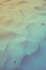 closeup of vintage filtered sand pattern of a beach in the summer