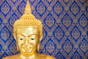 Fototapeta premium Buddha gold statue on blue background patterns Thailand.