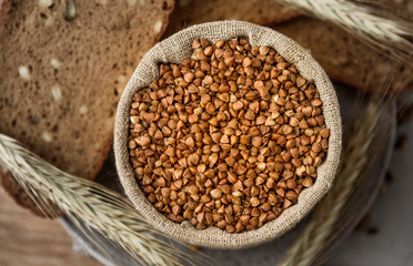 buckwheat in a linen bag in background grain bread
