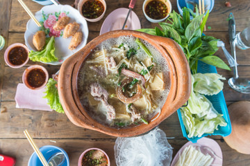 clay pot.Thai traditional spicy shabu shabu, dipping meat in boi