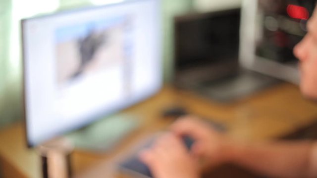 Blurred movie of man searching information in internet.