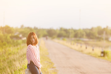 Young woman unhappy sitting on road in the reservoir.