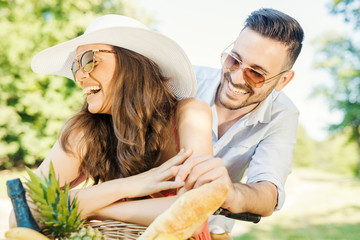 Happy young loving couple relaxing in the park