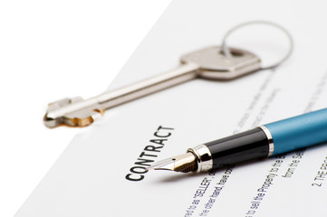 Keys of a new house and pen on contract.