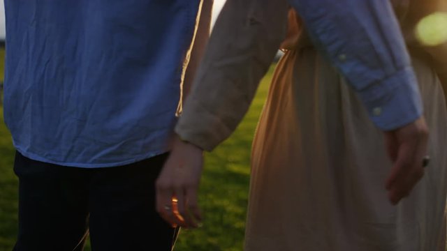 4K Couple standing hug as they look to horizon, in slow motion 