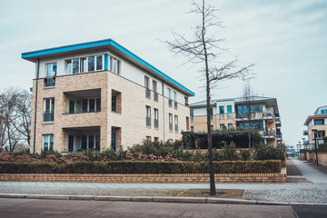 Fototapeta na wymiar Modern apartments with blue rimmed roof