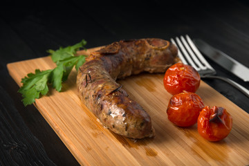 grilled sausages on a wooden board