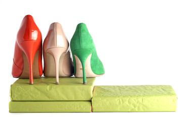 bright, multicolored female shoes on high heels isolated on white background