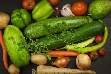 Various types of vegetables on an old wooden table. Sales of fresh vegetables. Dietary supplements for athletes.
