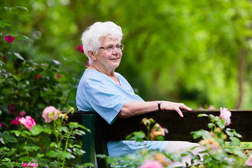 Senior lady in rose garden