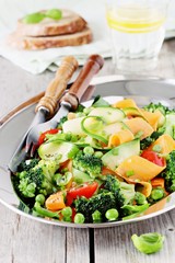 Summer vegetables salad with broccoli,zucchini,carrots,cherry tomatoes and green pea. Clean eating concept.Selective focus 
