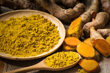 fresh turmeric roots with turmeric powder