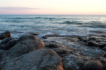 Fototapeta na wymiar Sunset on the rocky seashore