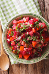 Homemade Russian vegetable salad in bowl close up. vertical top view
