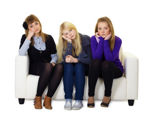Obraz premium Young girls are sad sitting on couch