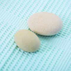 Two small round stone on towel