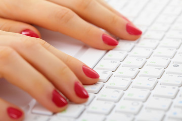 Obraz na płótnie Canvas Female hands on computer keyboard - typing