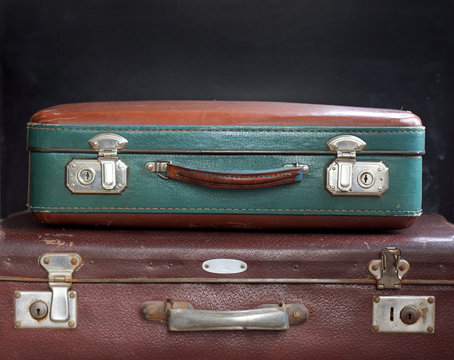 luggage time-tested/ Two suitcases on a dark background 