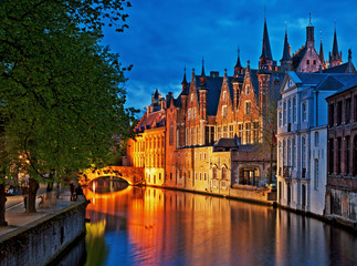 Fototapeta na wymiar Night shot of historic medieval buildings along a canal in Bruges, Belgium