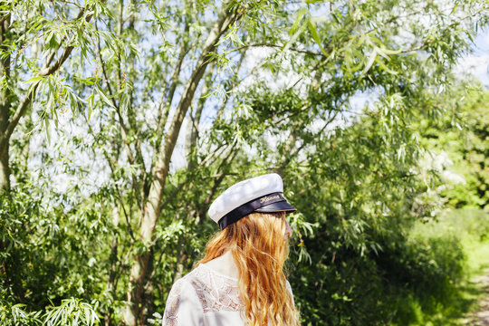 Female graduate looking away at university park
