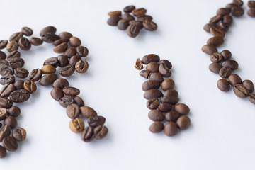 Coffee beans arranged shaped RIO heart on wood background.