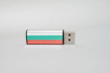 usb flash drive with the national flag of bulgaria on gray background