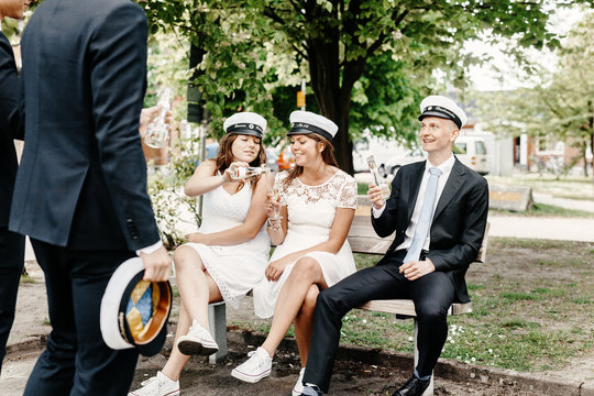 Happy university students having champagne at graduation party