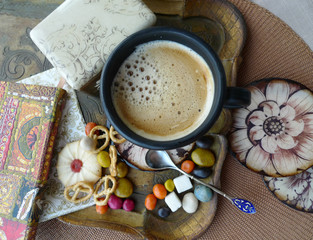 Fototapeta na wymiar Retro still life. A cup of coffee with cream, biscuits and sweets on a tray. Decoupage.