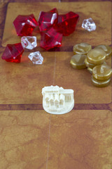 The white toy house with some chips on the orange background