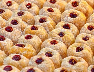 Donuts with powdered sugar on a tray