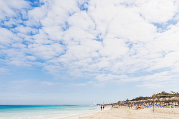 Tourists relax on Varadero sandy beach. Cuba.