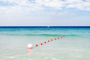 Fototapeta na wymiar Tourists float on a sailing catamaran. Active sports leisure. Varadero sandy beach at sunny day. Cuba.