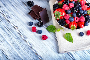 Bowl of berries with chocolate and mint.