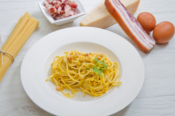 dish with carbonara's spaghetti and ingredients
