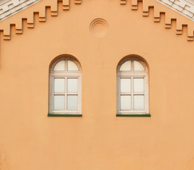 Fototapeta na wymiar Two windows on yellow wall