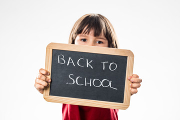 determined child warning about back to school on writing slate